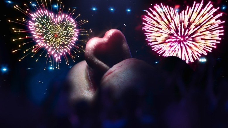 Tongue twisted in heart shape with fireworks