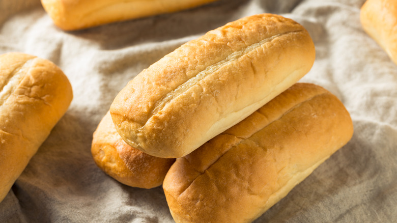 A small pile of Italian bread rolls arranged together