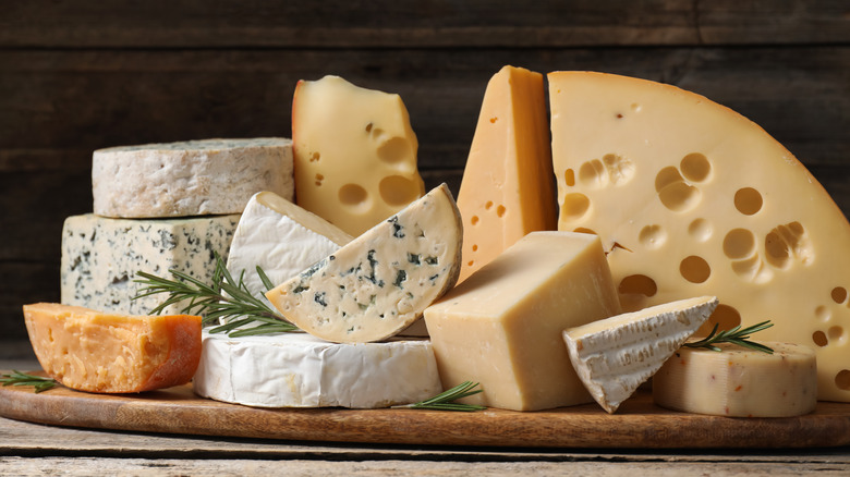 A selection of several different cheese varieties piled together