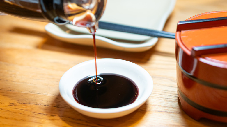 Soy sauce being poured into bowl