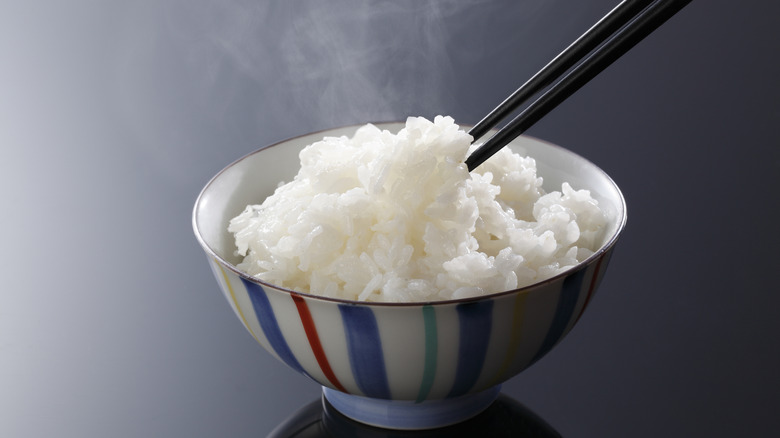Chopsticks in rice bowl