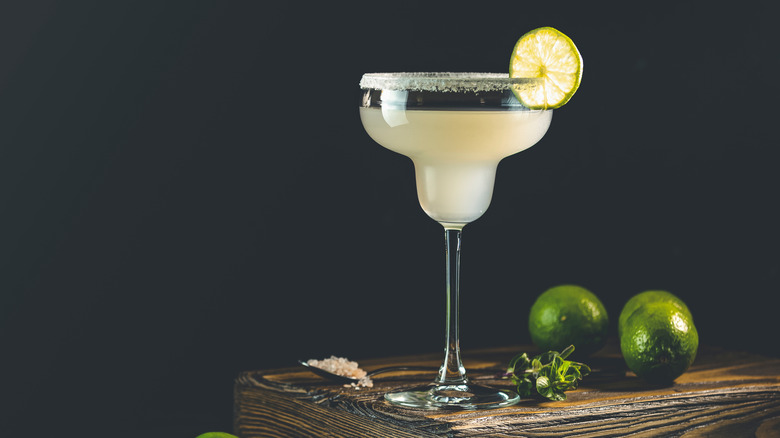 Stemed glass with lime cocktail in it