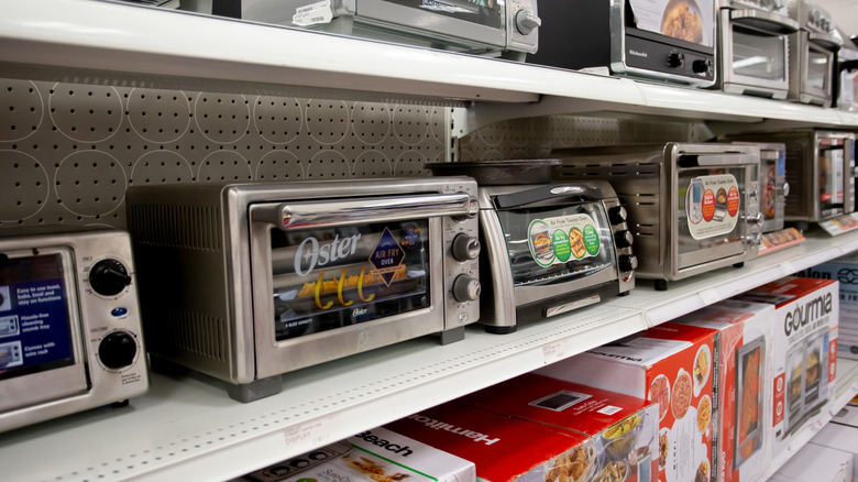 A row of toaster ovens on display in a store