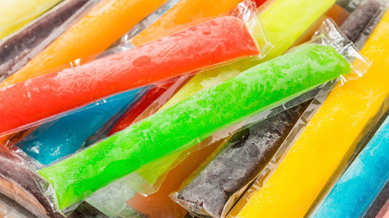 Pile of generic freezer pops in a variety of colors like yellow, green, purple, orange, coral/red, and blue.