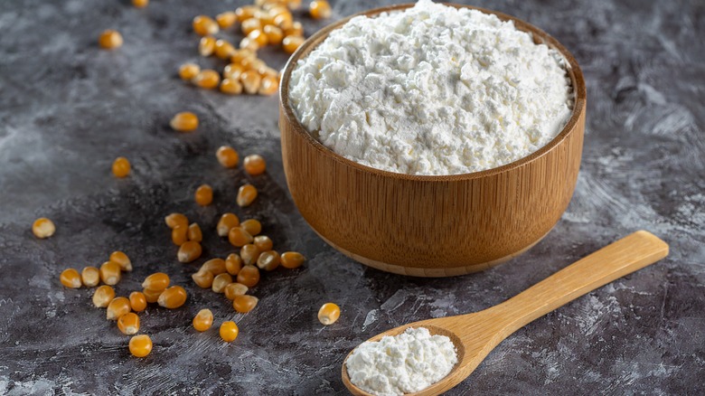 cornstarch in a bowl with kernels scattered nearby