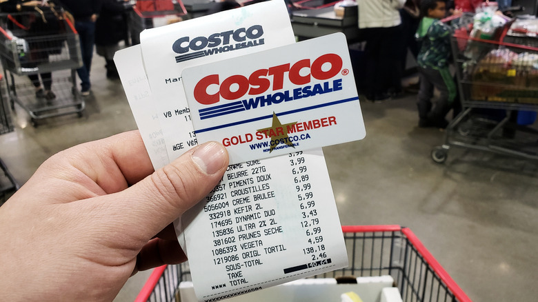 Costco receipt with membership card and cart