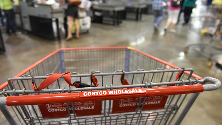 A Costco sign on the outside of a warehouse building during the day