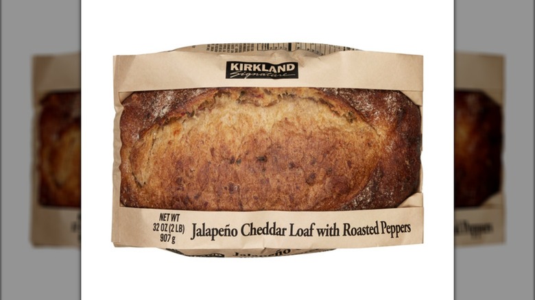 Costco's Jalapeño Cheddar load with roasted peppers inside a brown bag with a clear middle window