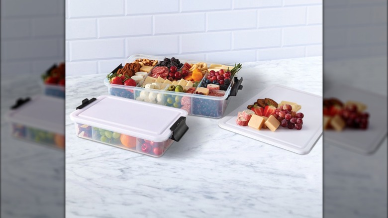 Clear, compartmented plastic trays with white plastic lids