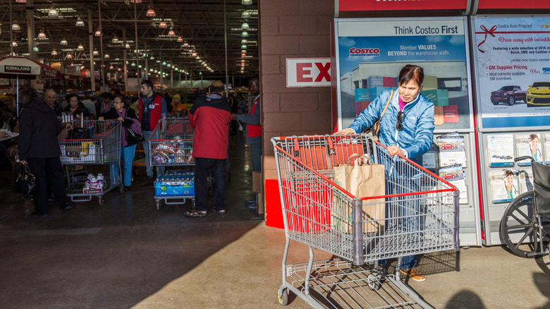 Woman pushing Costco shopping cart