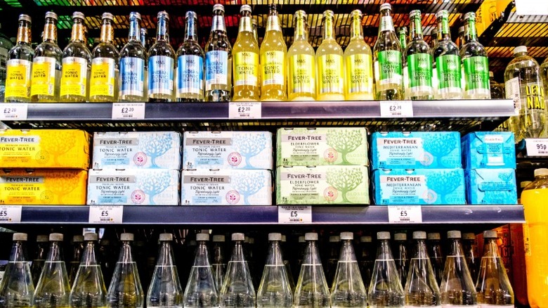 bottles of popular drink mixers on a supermarket shelf