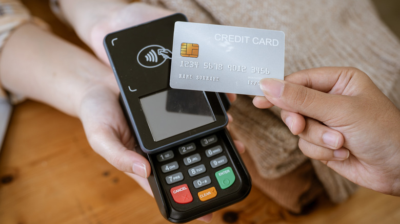 A customer taps their credit card on a card machine