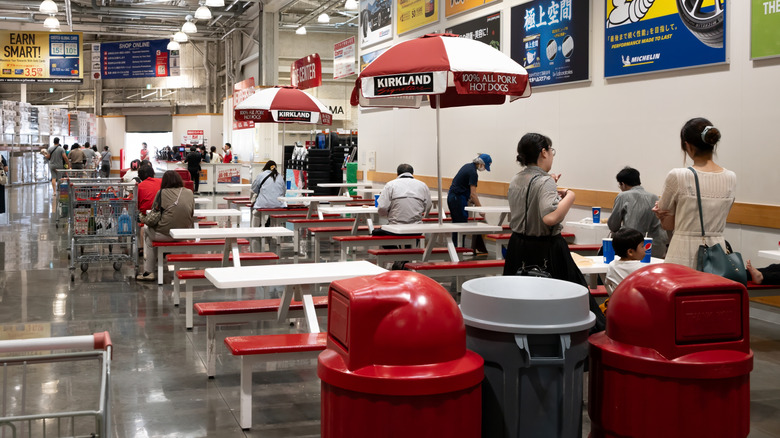 People sit at tables in a Costco food court