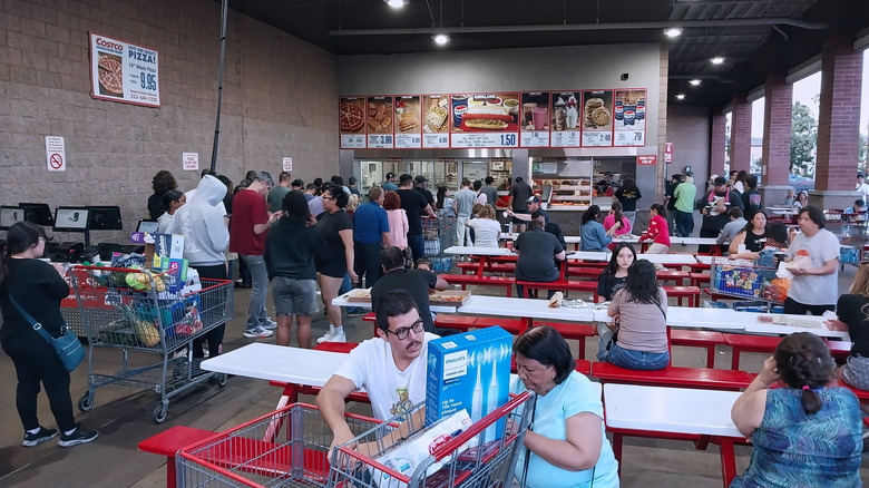 Costco shoppers wait in line at a food court