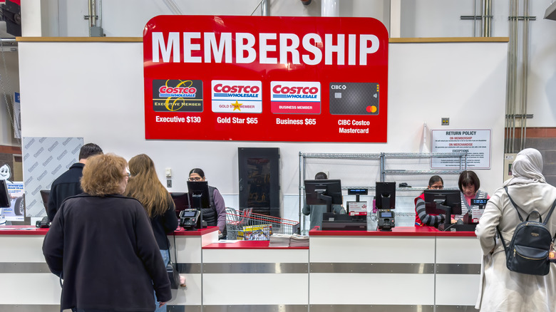 A membership counter at a Costco store, with customers queueing to speak to employees