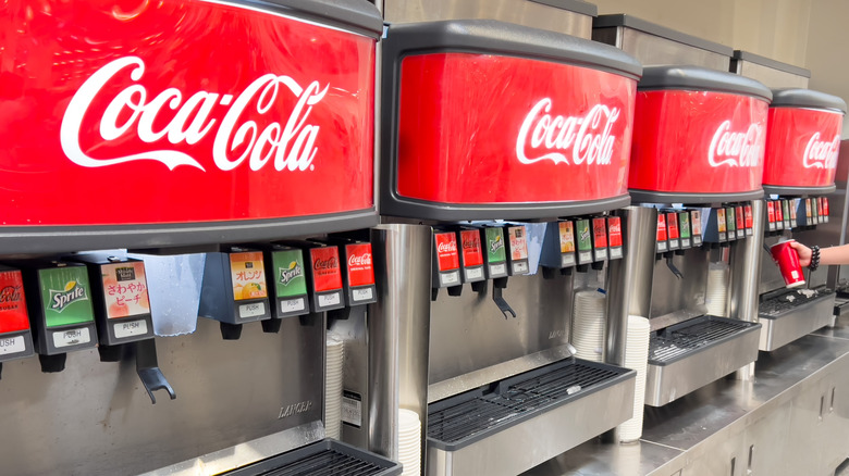 A row of Coca-Cola machines in a Costco food court