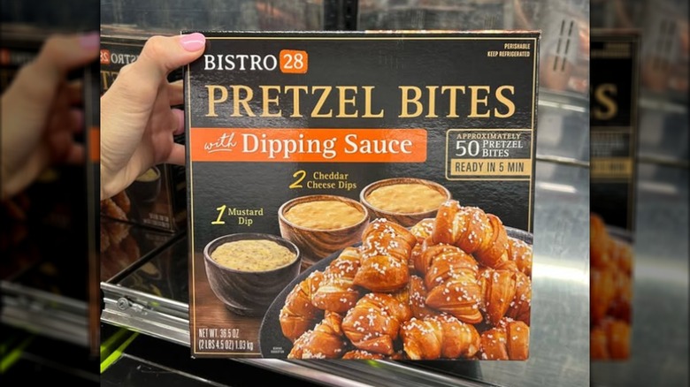 Hand holding box of Bistro 28 Pretzel bites