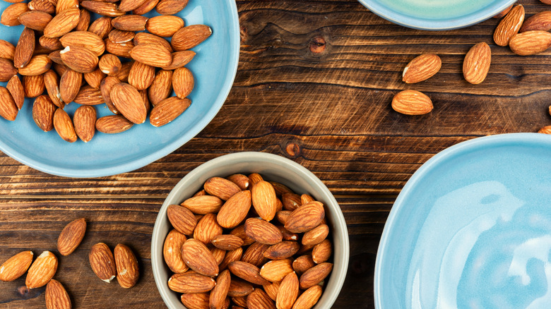 Almonds in a bowl and on a blue plate