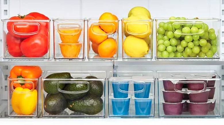 brightly colored vegetables and fruit in storage boxes in the fridge