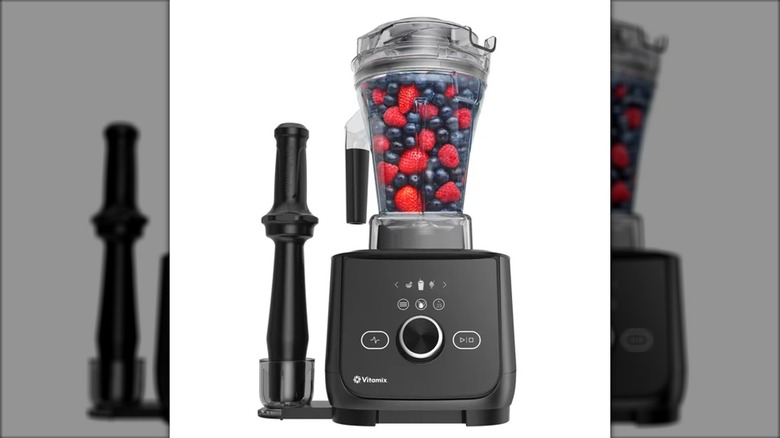 a vitamix blender with strawberries and blueberries