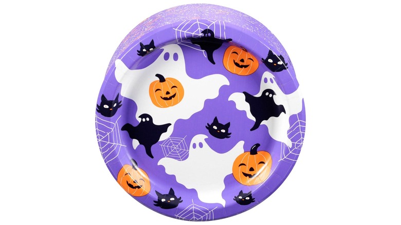 A purple plate with ghosts, black cats, and jack-o'-lanterns
