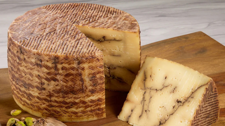 Don Juan Black Garlic Sheep's Milk Cheese on wood board
