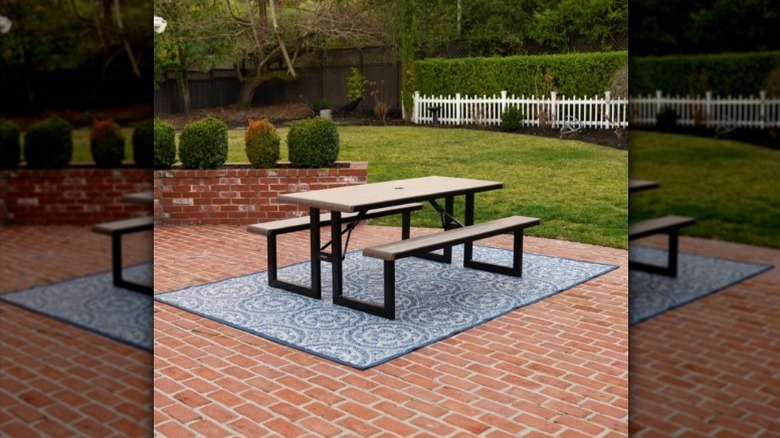 Lifetime six foot folding picnic table on outdoor rug outside