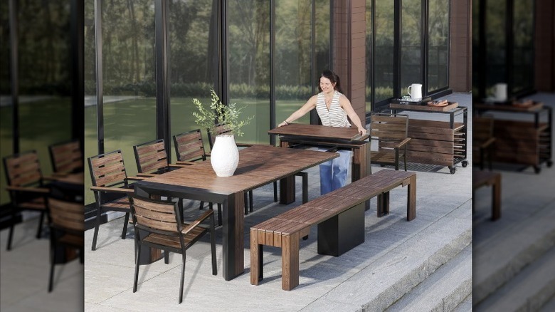 Person adds panel to transformer table outside