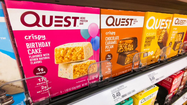 Quest protein bar boxes lined on shelves