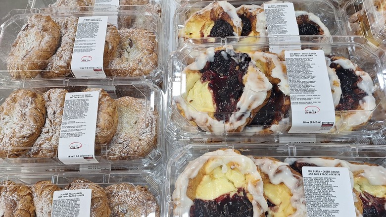 Costco mixed berry and cheese danishes and almond danishes on display in the bakery