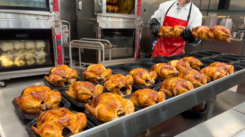 Costco employee with rotisserie chickens