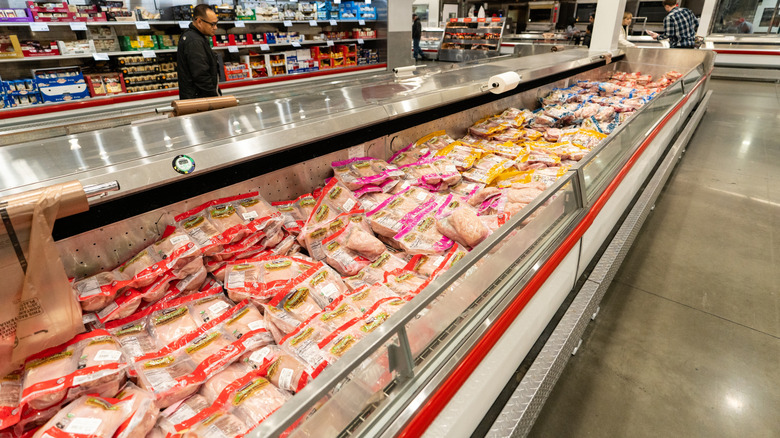 A ros of various packaged chicken in a Costco