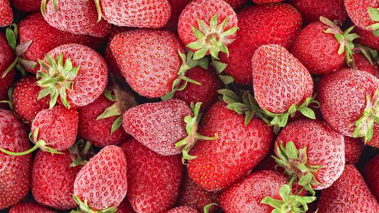 Many frozen strawberries piled together