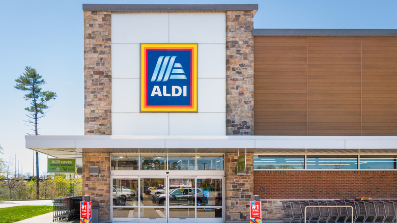 Exterior of an Aldi store against a bright blue sky