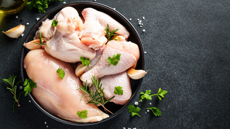 different cuts of chicken in a black bowl