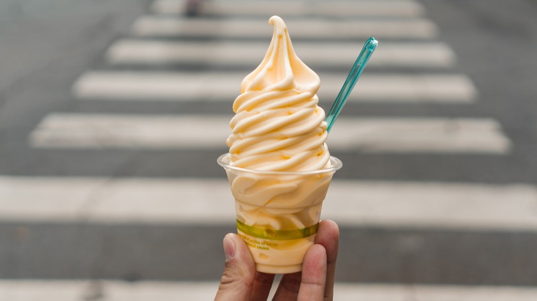 hand holding a cup of Dole Whip