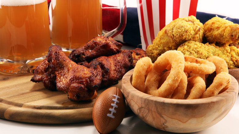 spread for the super bowl with wings, onion rings, mozzarella sticks, and beer