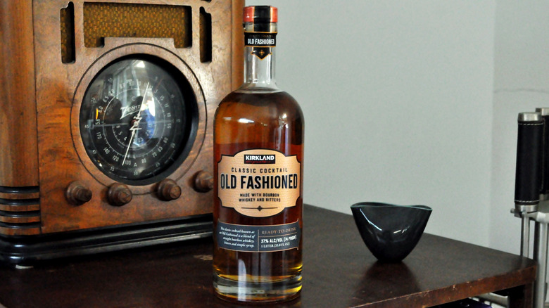 Bottle of Kirkland's Old Fashioned next to a vintage radio