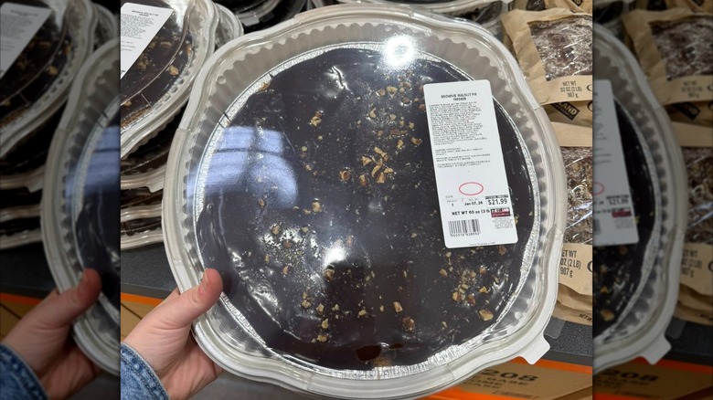 Person holding a Brownie Walnut Pie at Costco