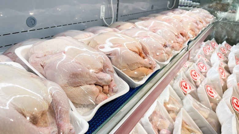 Raw chicken packaged on shelves