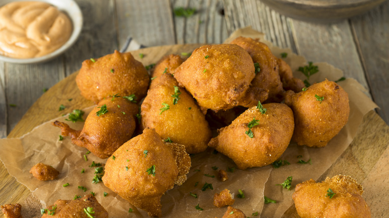 Hush puppies on board with sauce