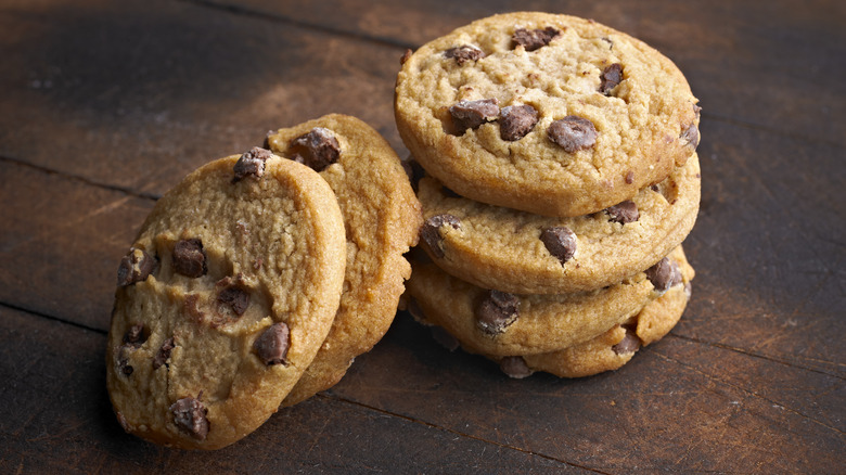 stack of chocolate chip cookies wood counter