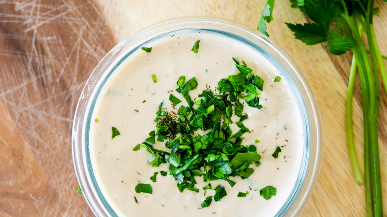 Creamy salad dressing garnished with parsley