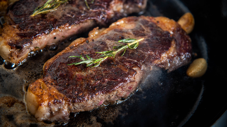 Steak browning in a pan