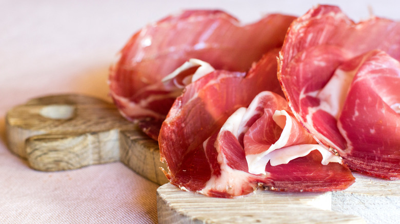 Sliced salumi on wooden board