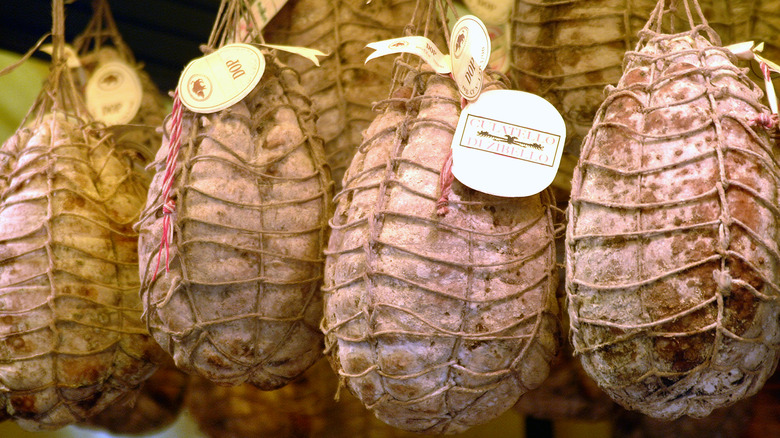 Culatello bags hanging in basement