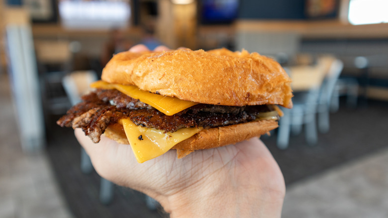 butter burger held up by hand