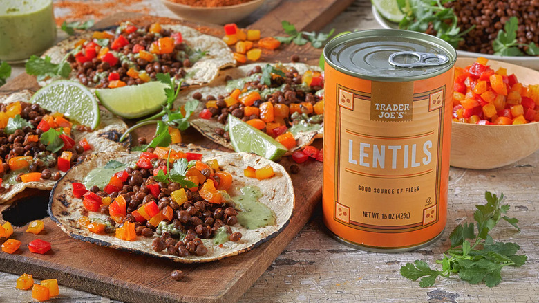 a table set with lentil and bell pepper tacos laid out, with a can of Trader Joe's canned lentils sitting in the foreground