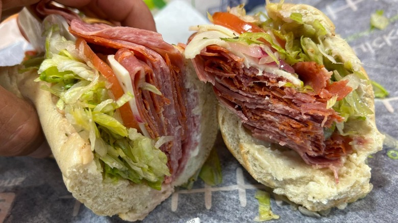 A Quick Chek Italian sandwich stuffed with deli meats and veggies on paper