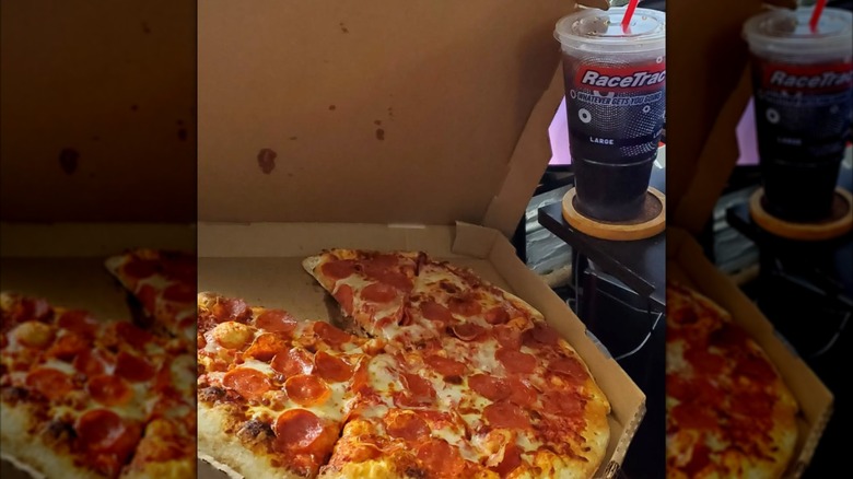 A photo of several cooked pizzas on display at RaceTrac